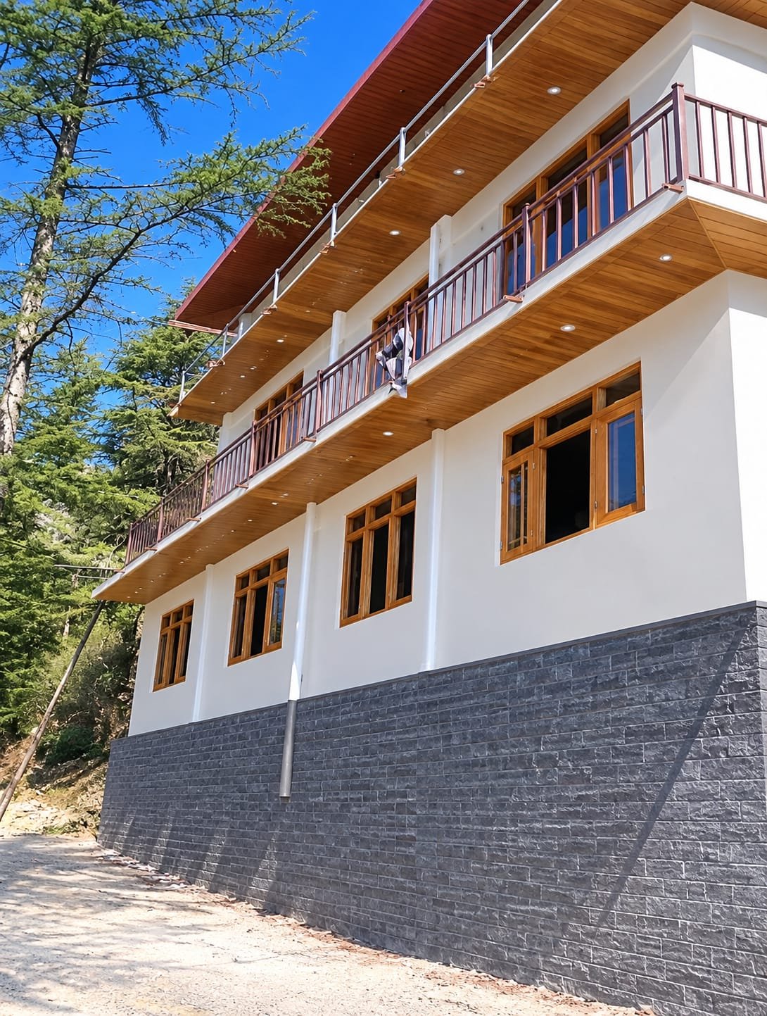Deodar balconies of Shali Homestay against the pine forest